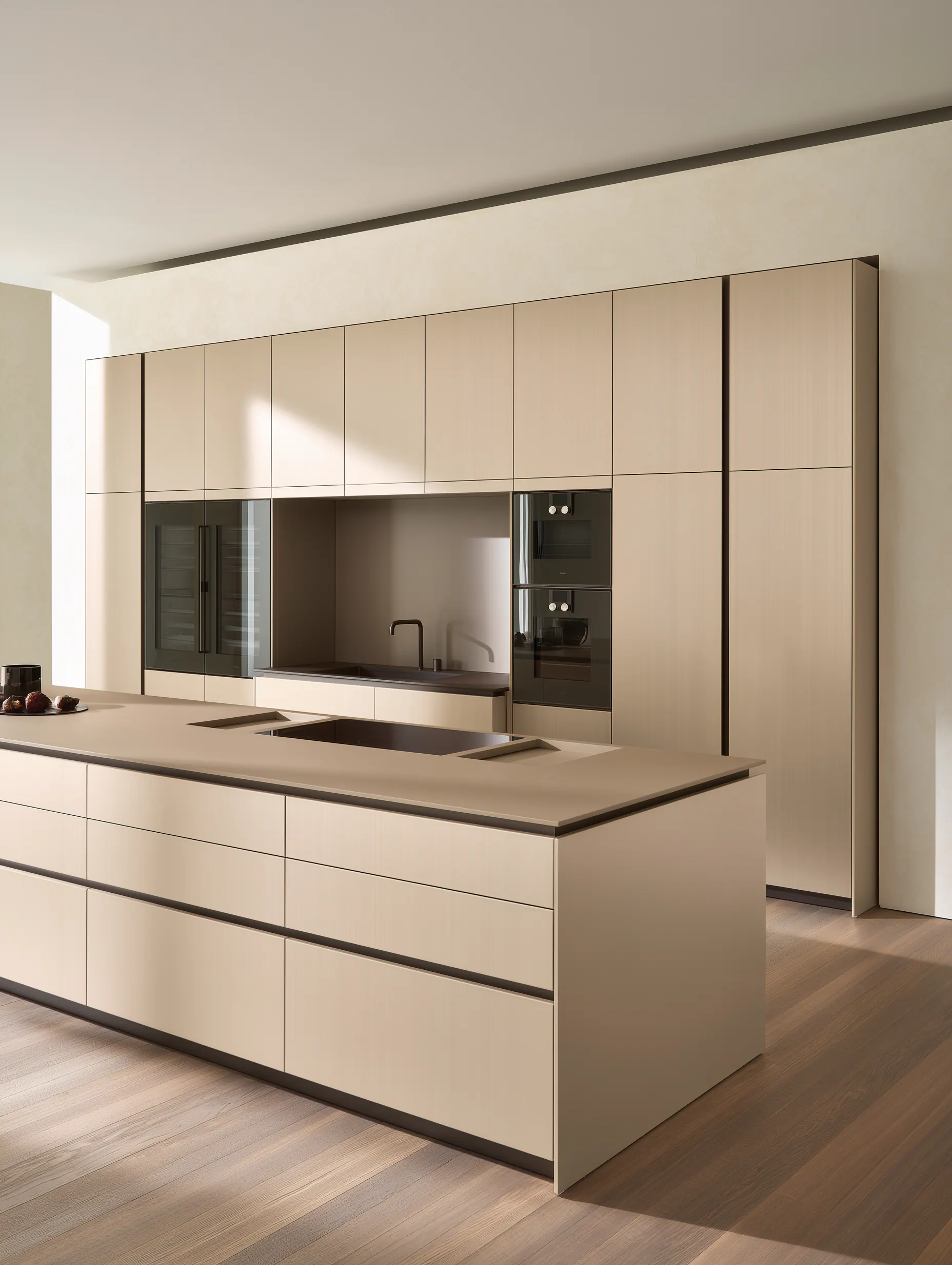Warm neutral aluminum kitchen with a long island and full-height integrated cabinetry