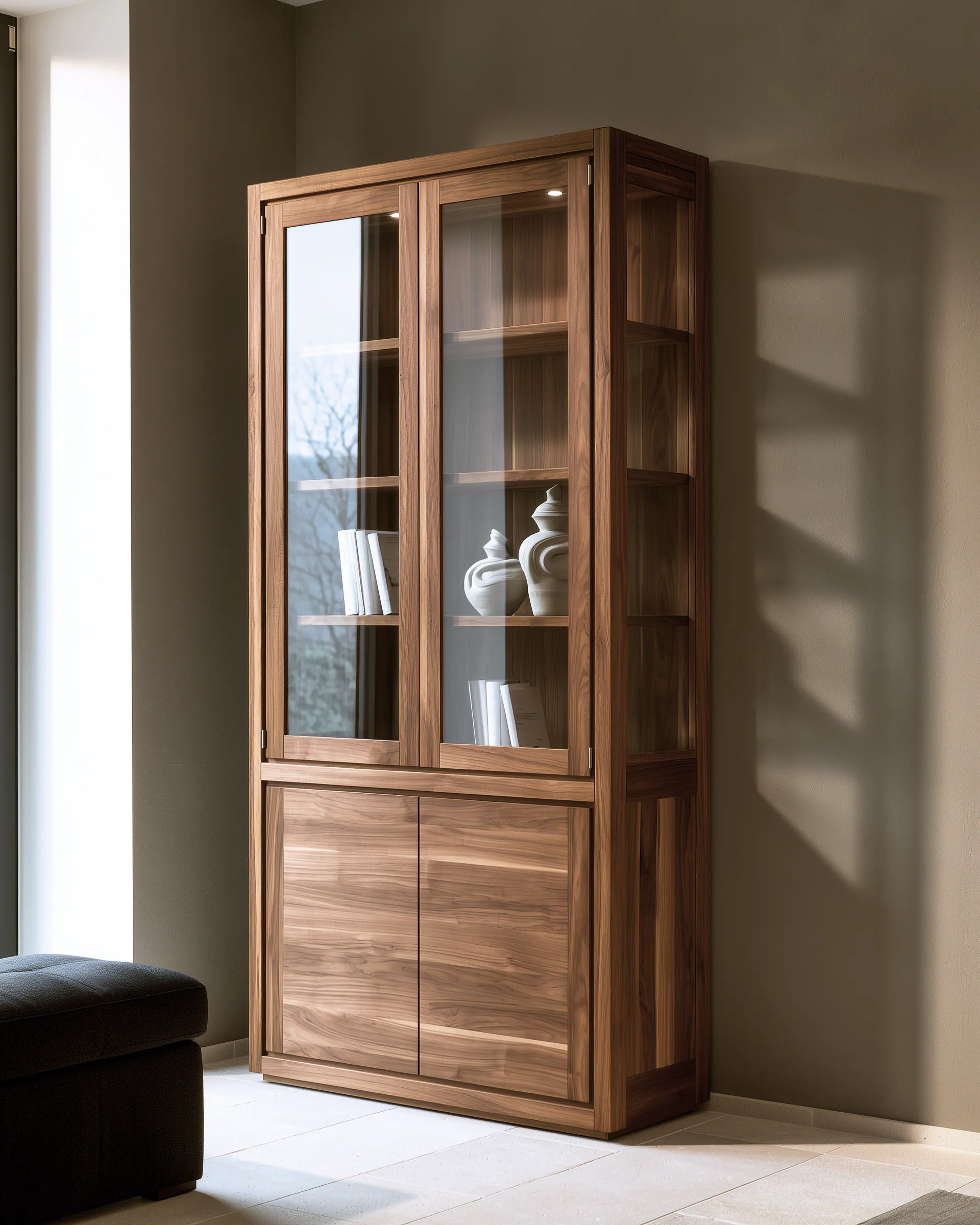 Tall walnut and glass living room cabinet with clear shelves and lower concealed storage