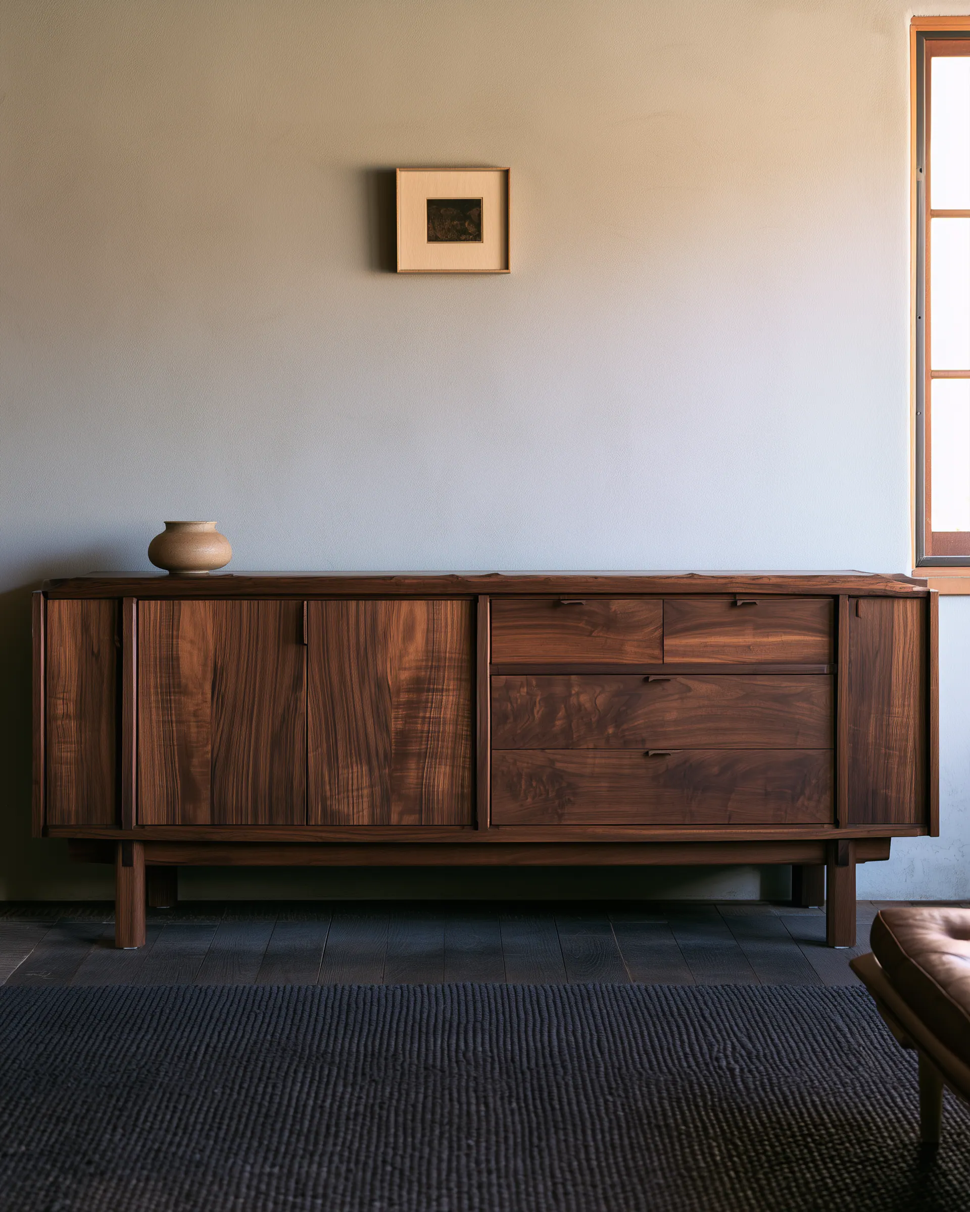 Wide dark wood living room sideboard with drawers, doors and a continuous raised base